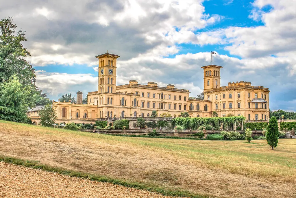 Osborne House on the Isle of Wight, a beautiful summer home built in 1851 for Queen Victoria, showcasing its Italianate architecture and lush garden surroundings.